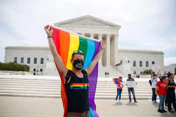 An LGBTQ supporter walks with a flag in front of the Supreme Court in Washington, DC, USA, 15 June 2020.